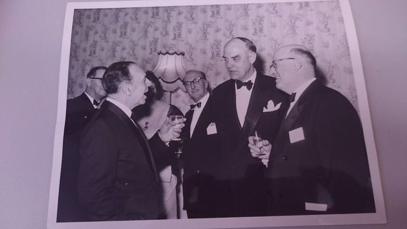 Archive photograph of members in black tie in conversation at an Institute dinner